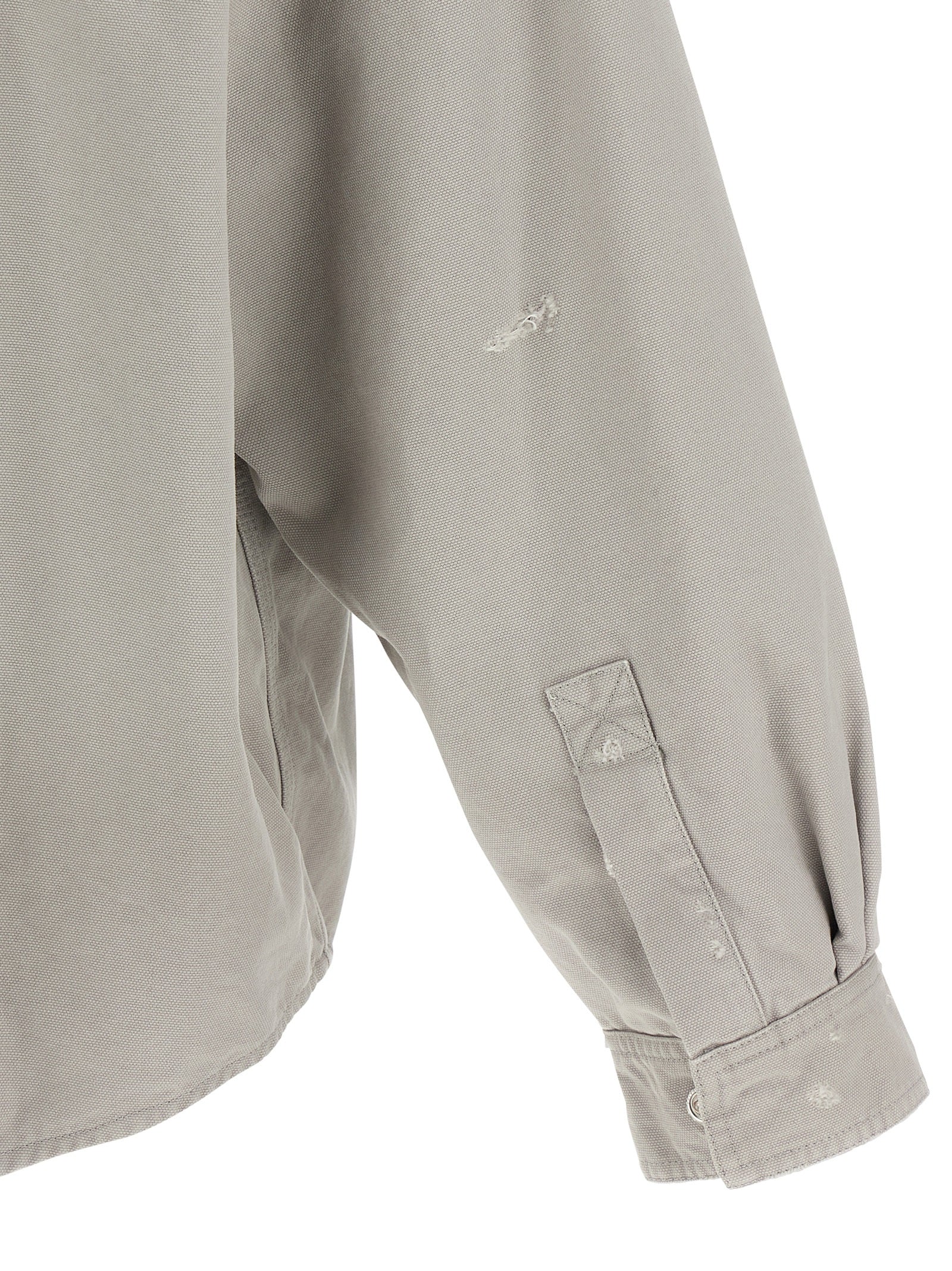 Blouse en coton gris de Balenciaga, image montrant le design élégant et la texture douce du tissu.