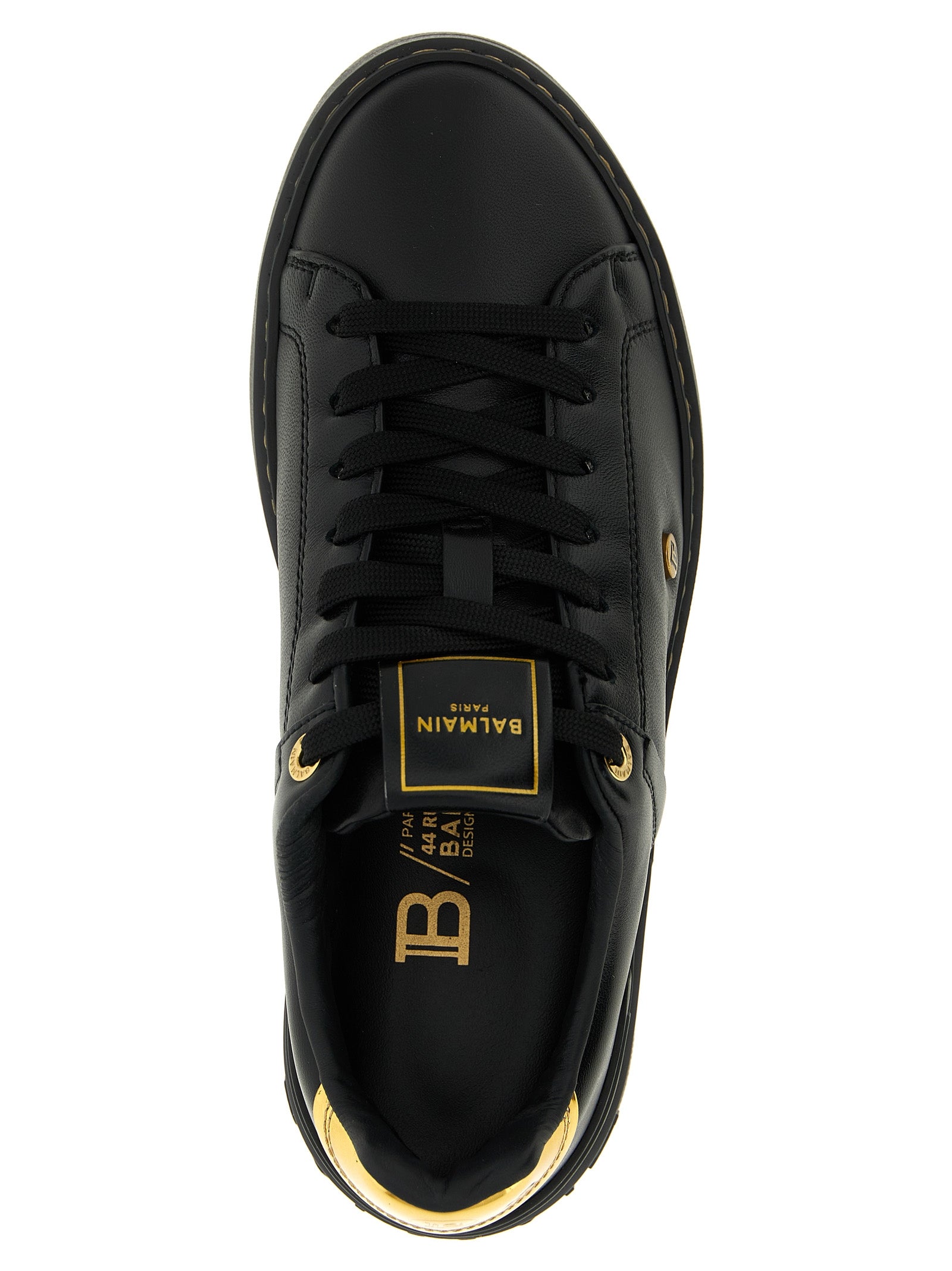 Sneakers basses en cuir d'agneau noir Balmain, style décontracté avec semelle blanche et design élégant.