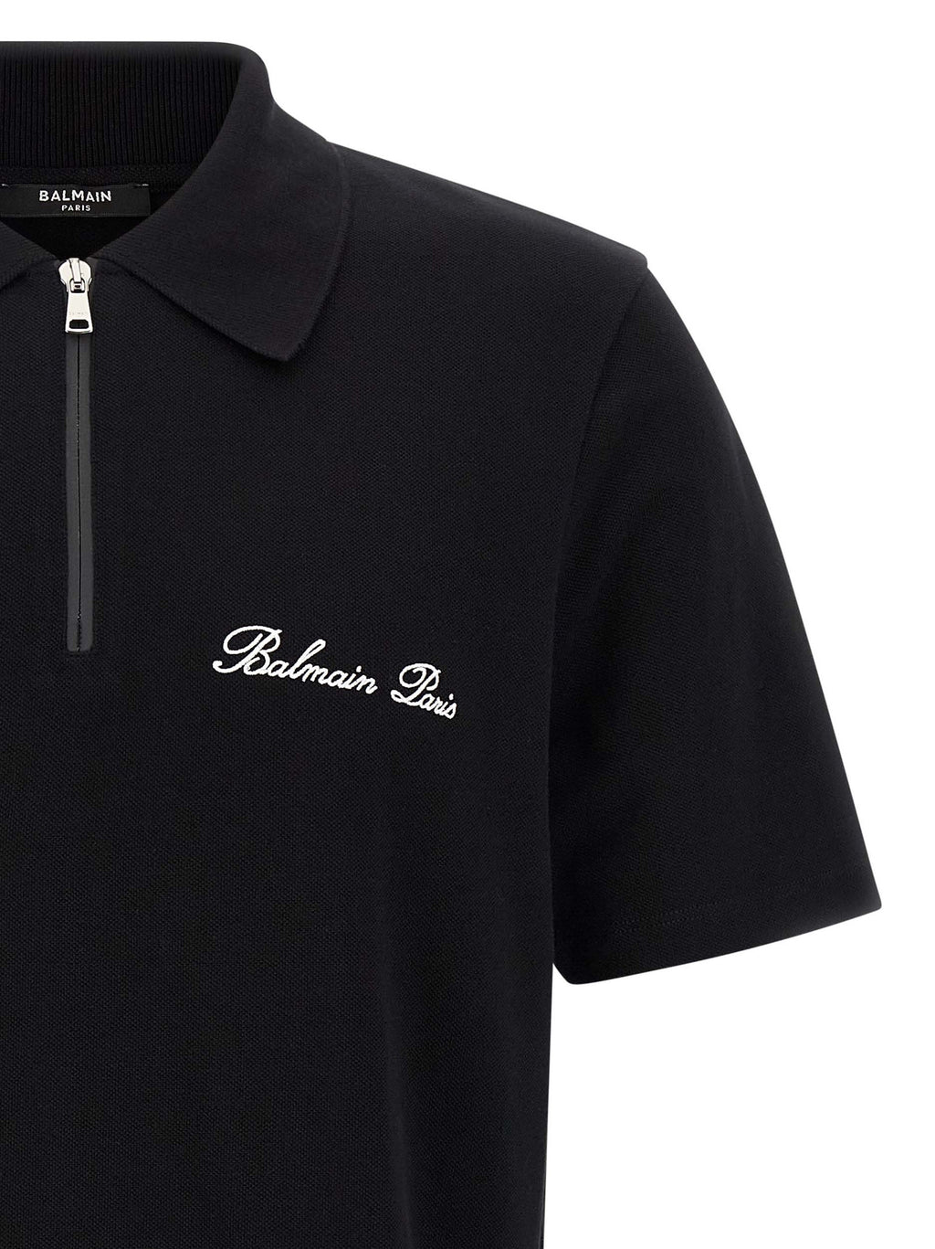Chemise polo en coton bicolore de Balmain, avec col classique et logo discret, vue de face sur fond neutre.