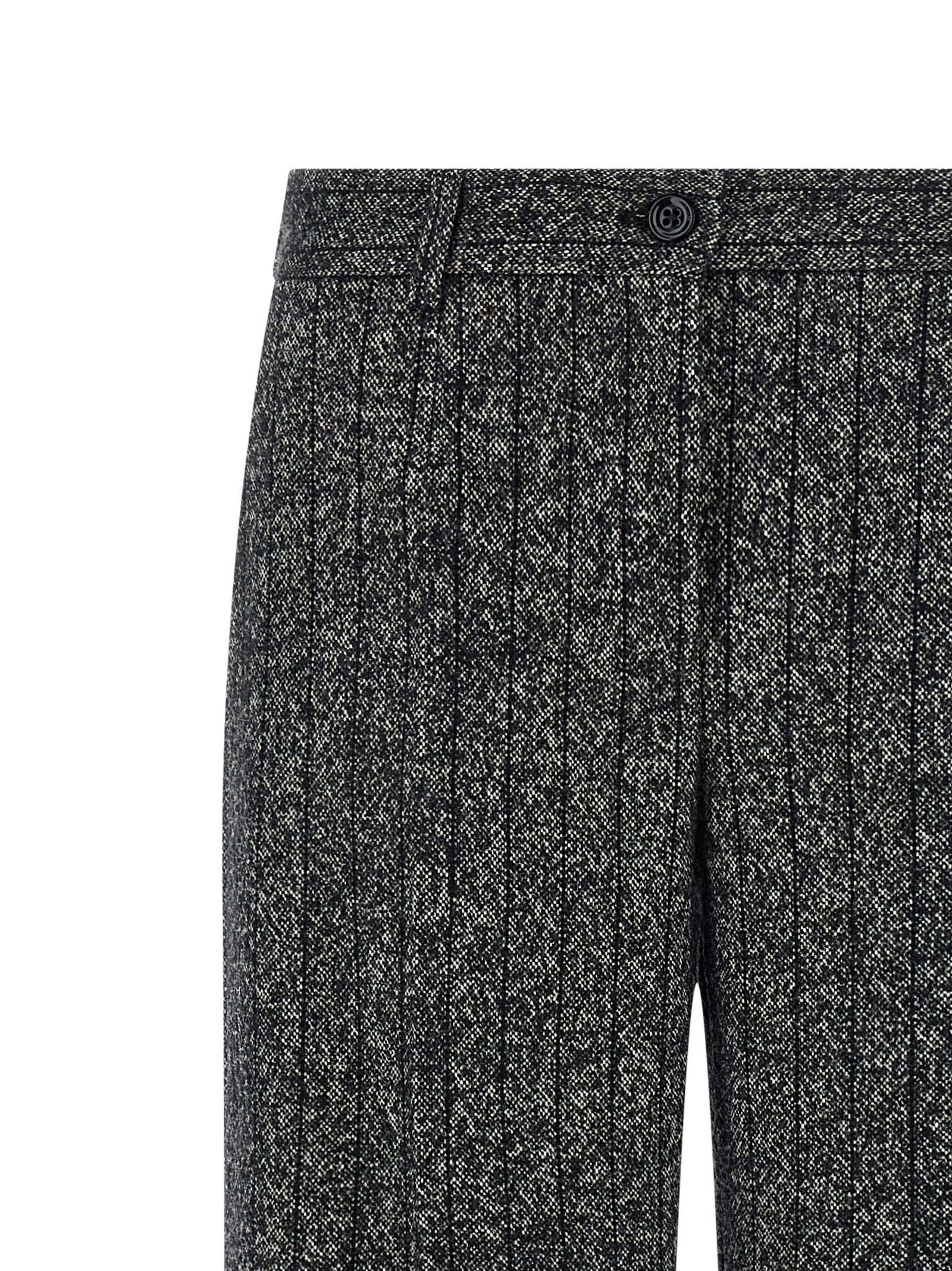 Pantalons décontractés en laine vierge bicolore de Dolce & Gabbana, style élégant et confortable, visibles en gros plan.