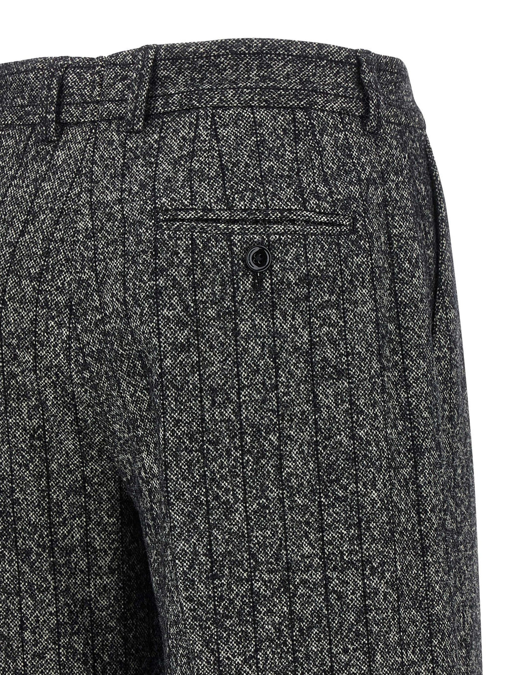 Pantalon décontracté en laine vierge bicolore de Dolce & Gabbana, style casual, visible avec coupe élégante et détails modernes.