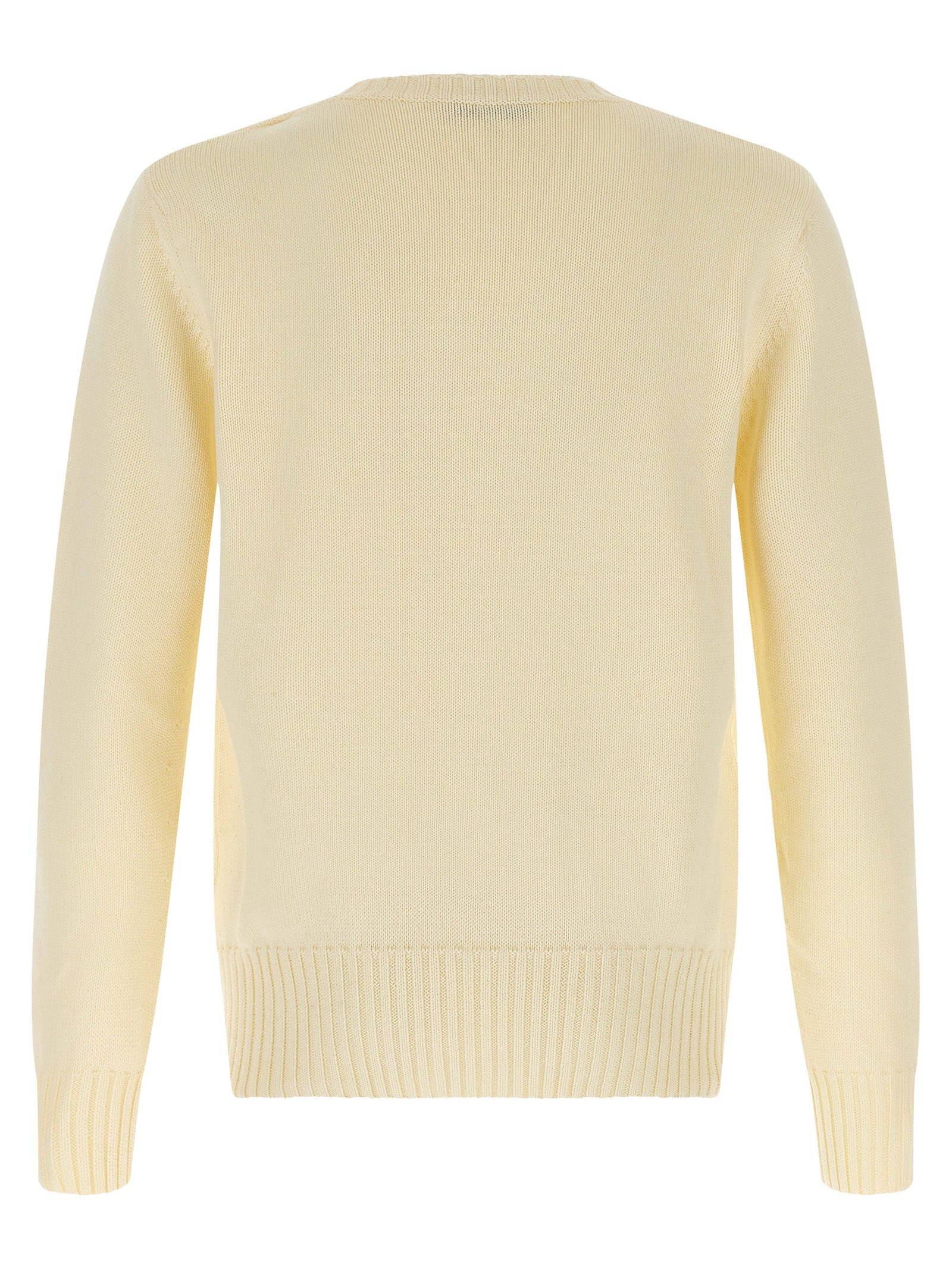 Cardigan en coton beige Givenchy avec boutons, porté sur un modèle, détail des manches et du col visible dans l'image.