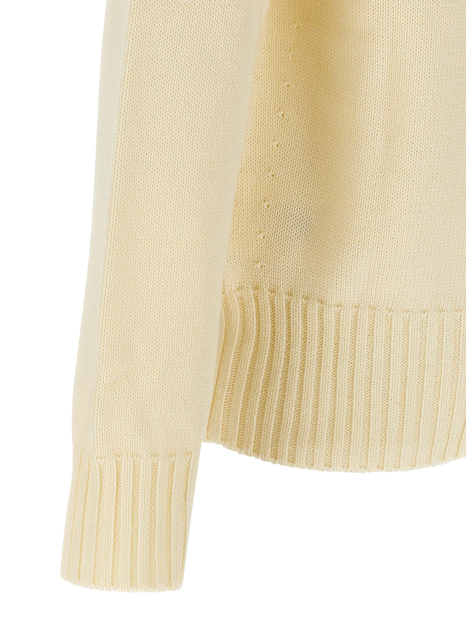 Cardigan en coton beige Givenchy, vue en gros plan, détaillant la texture douce et le design élégant du vêtement.