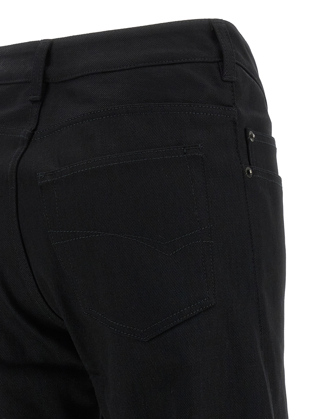 Jeans évasés en coton noir de la marque Balenciaga, coupe fluide et style tendance visible sur l'image.