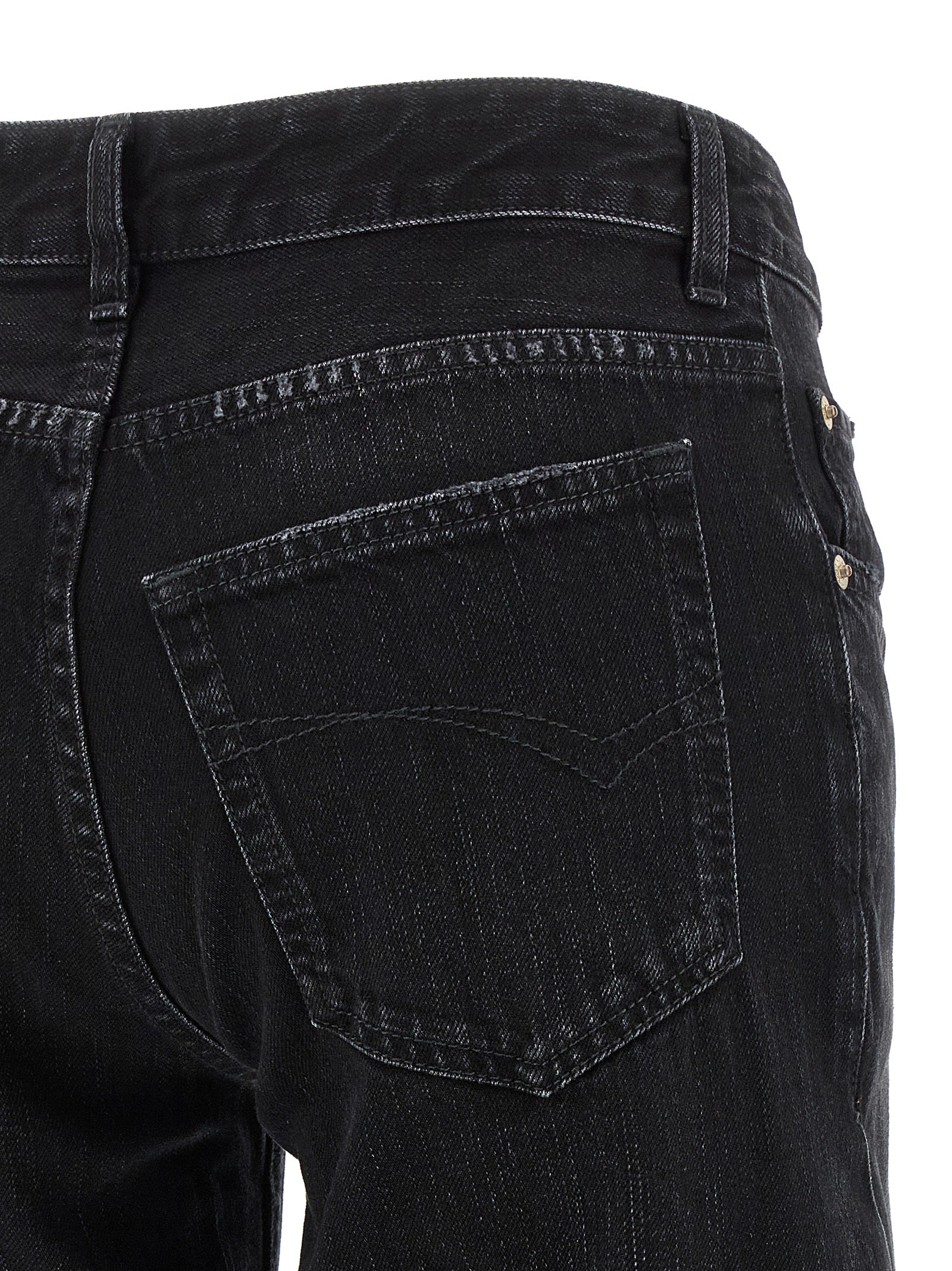 Jeans évasés en coton noir de la marque Balenciaga, coupe ample et style tendance, visible en détail sur l'image.