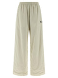 Pantalons de jogging beige en polyamide de Balenciaga, style décontracté, avec ceinture élastique et poches latérales visibles.
