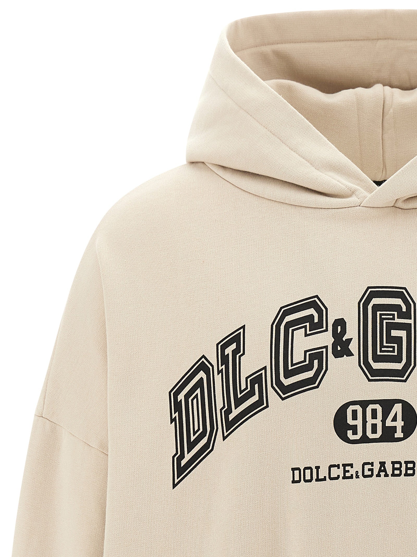 Sweat-shirt beige en coton de Dolce & Gabbana, tissu doux et confortable, avec logo discret sur la poitrine.