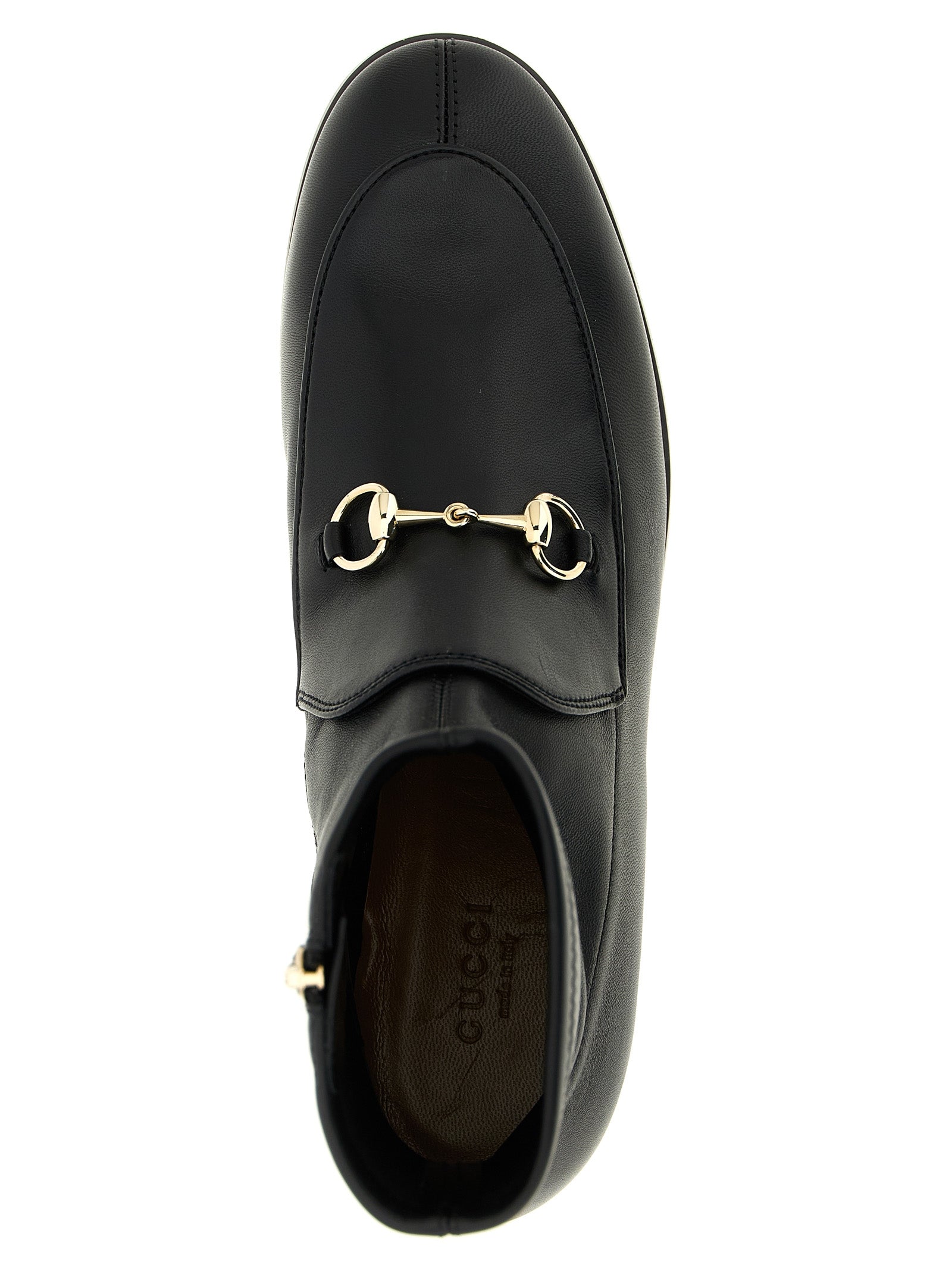 Bottes ankle en cuir d'agneau noir de Gucci, style élégant avec détails sophistiqués, visibles sur l'image.