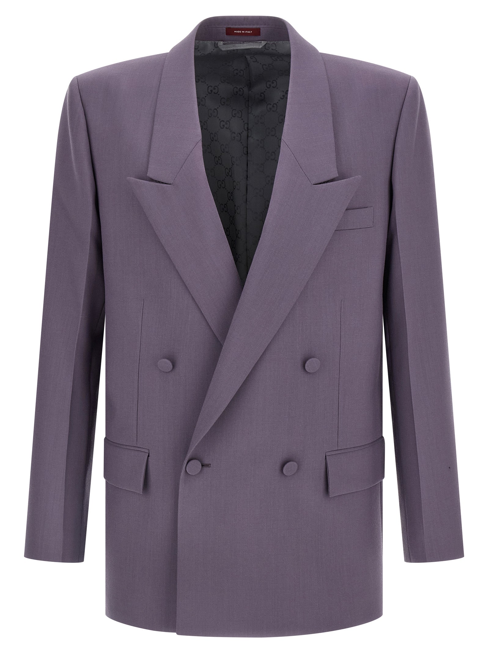 Veste blazer en laine violette de Gucci, coupe élégante, portée sur un fond neutre, mettant en valeur le tissu et la finition haut de gamme.