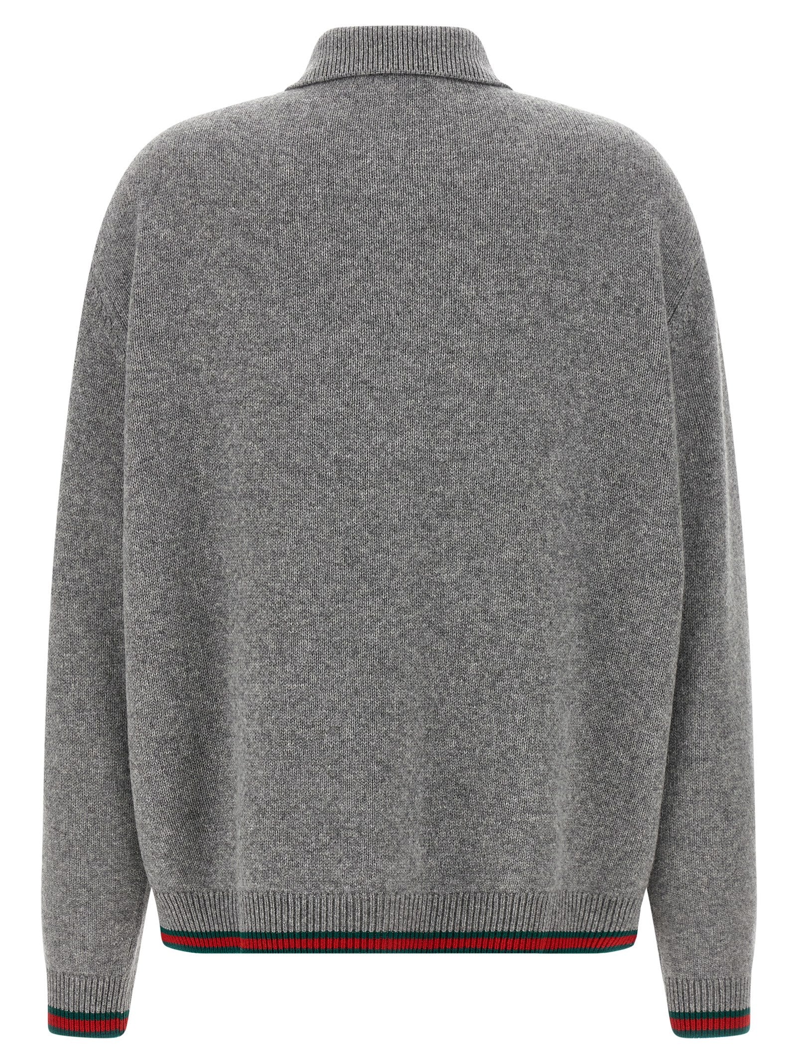 Cardigan en laine gris de Gucci, pull à manches longues avec logo Gucci sur la poitrine, porté sur un mannequin.