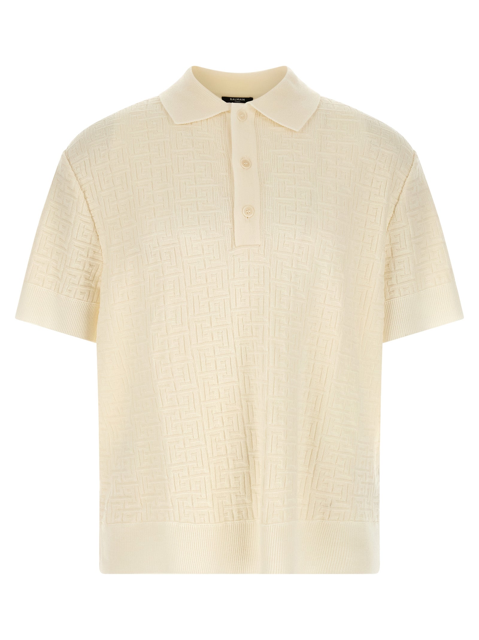 Chemise polo en laine blanche Balmain, vue détaillée du devant avec col et boutons, tissu doux et élégant.