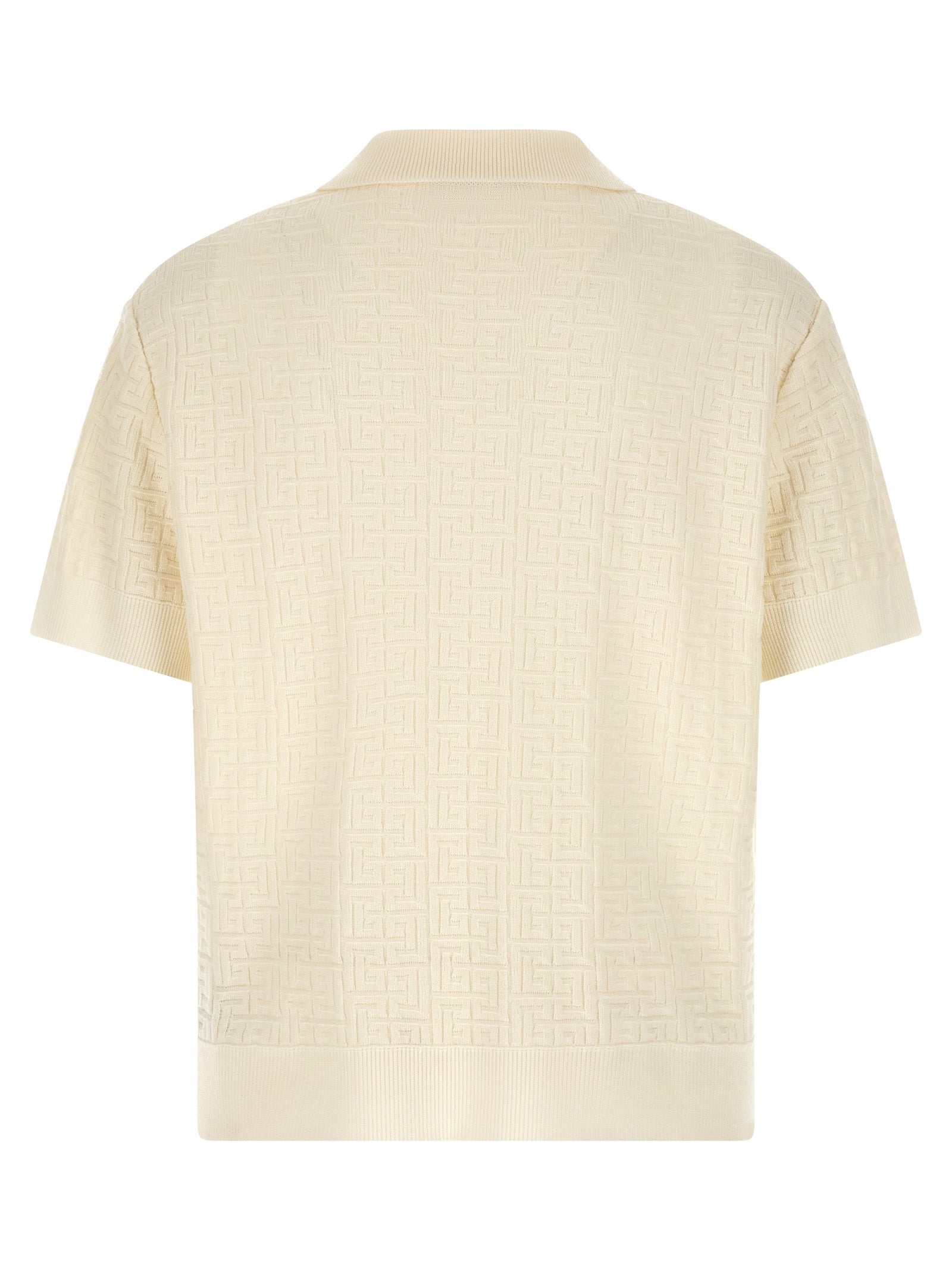 Chemise polo en laine blanche Balmain, vue de face, détails du col et du logo sur la poitrine.