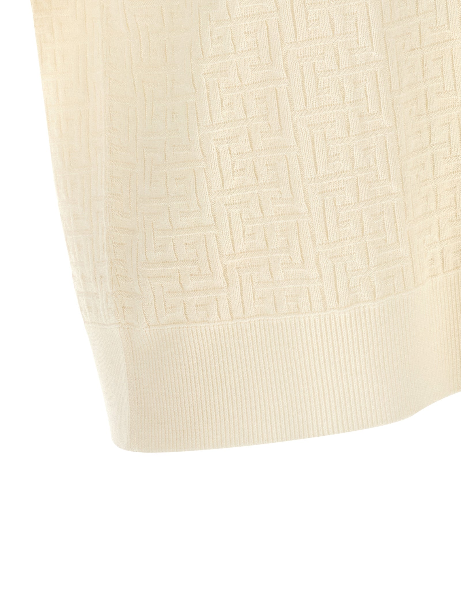 Chemise polo blanche en laine Balmain, vue de face, détails du col et du logo brodé, style élégant et sophistiqué.