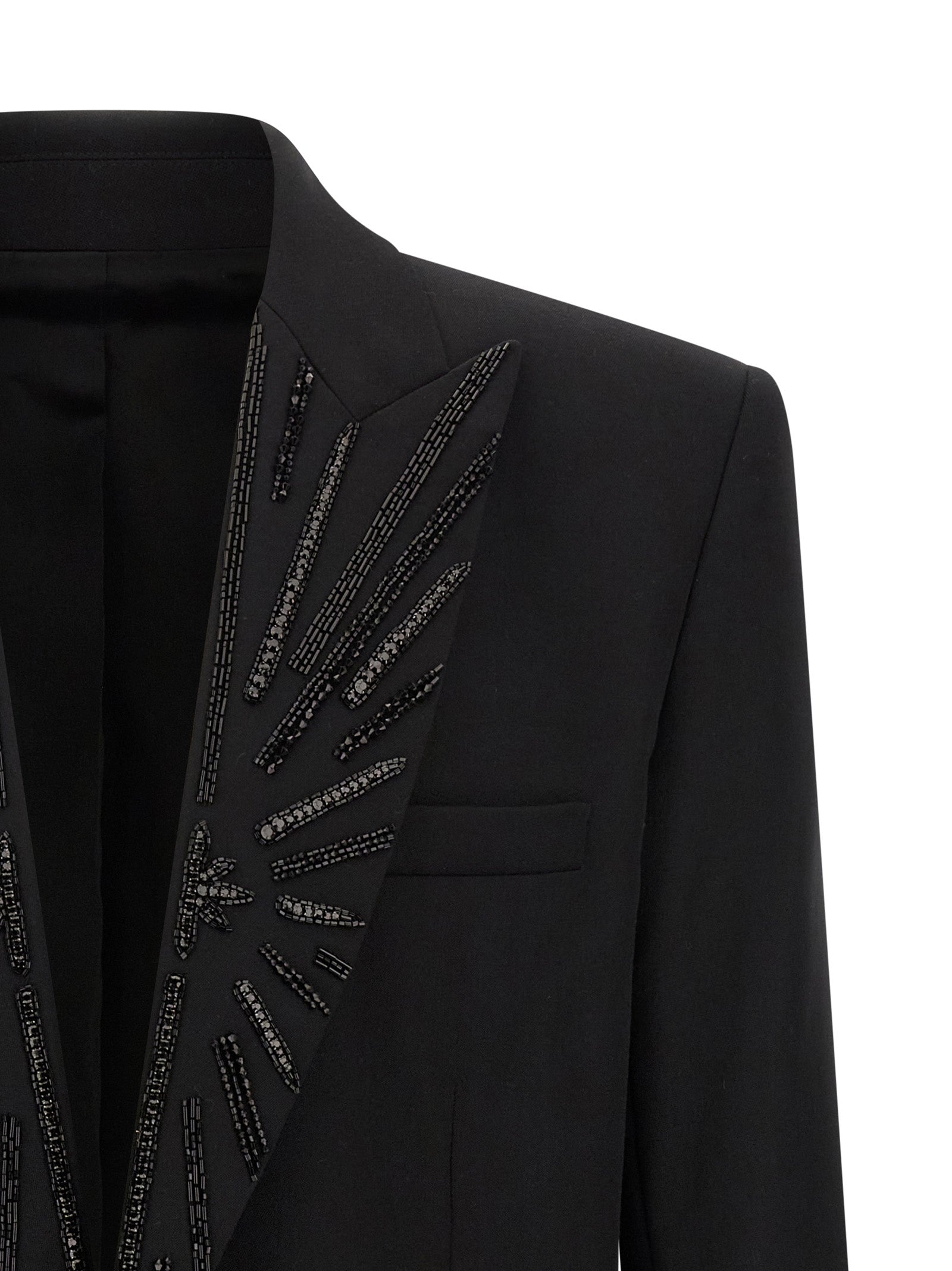 Blazer noir en laine vierge de Balmain, coupe élégante, avec revers classiques et détails modernes pour un style sophistiqué.