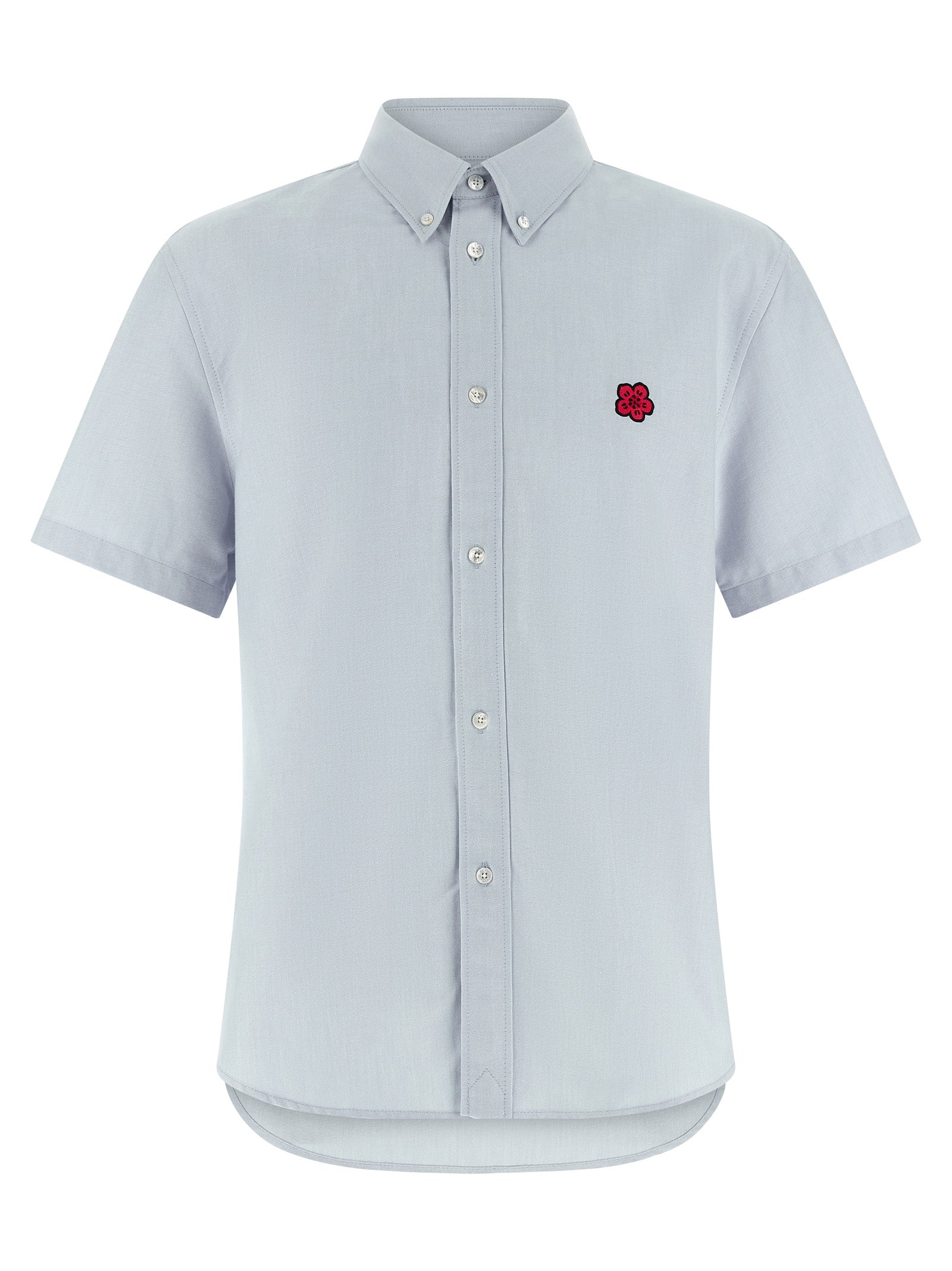 Chemisier en coton bleu de la marque Kenzo, avec détails stylés et coupe élégante, porté sur un mannequin blanc.