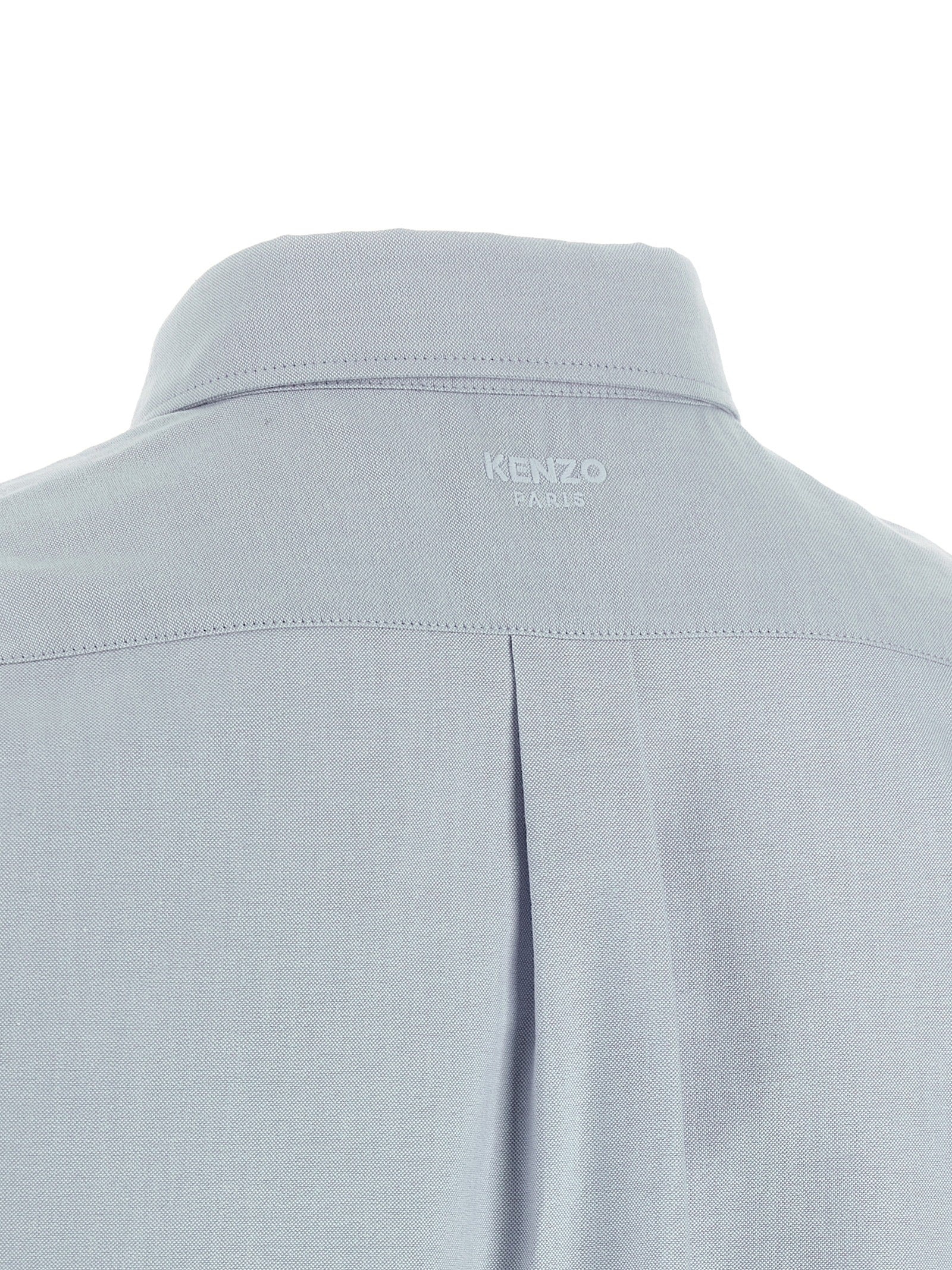 Chemise en coton bleu Kenzo, élégante blouse avec détails modernes, portée décontractée ou sophistiquée.