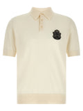 Chemise polo blanche en coton Dolce & Gabbana avec col classique et logo discret, vue de face.