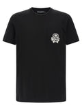 T-shirt en coton noir de la marque Dolce & Gabbana, coupe classique, visible sur un mannequin avec logo discret.