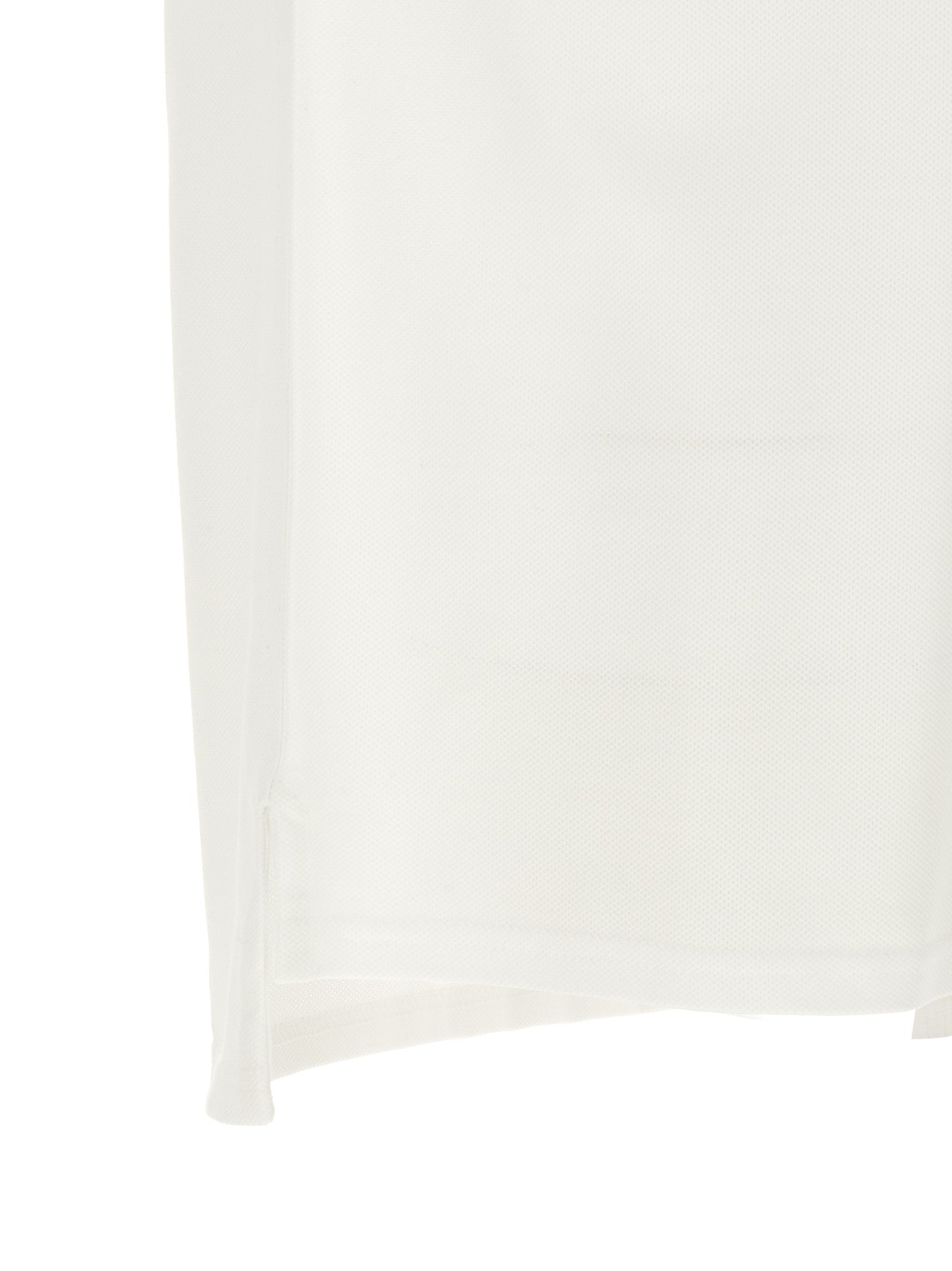 Chemise polo blanche en coton de la marque Givenchy, vue de face avec col et boutons visibles.