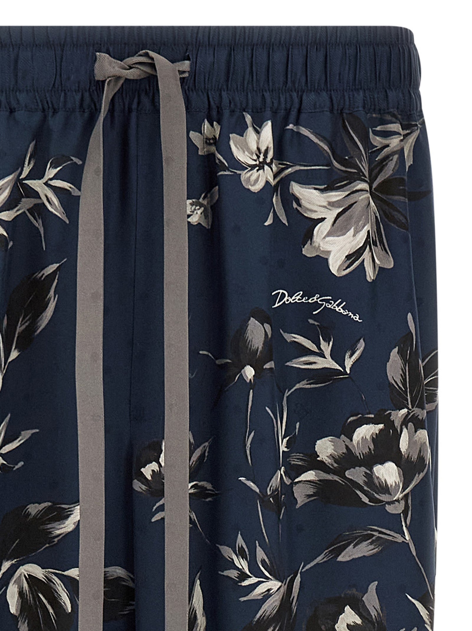 Pantalon décontracté en soie bleue de Dolce & Gabbana, coupe élégante et tissu fluide, idéal pour un style chic et confortable.
