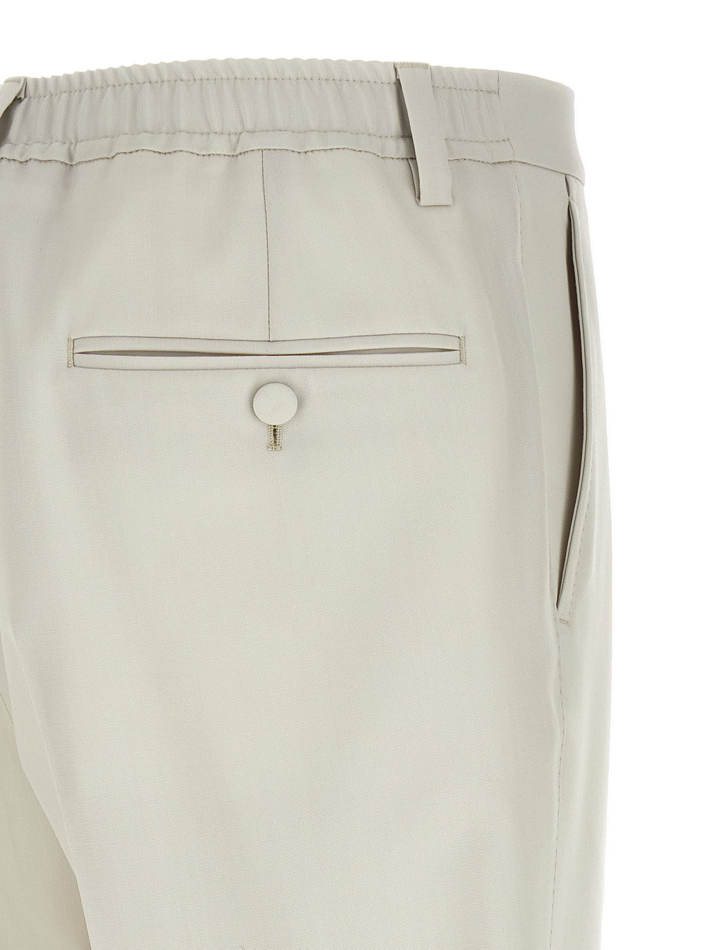 Pantalon de costume beige en laine vierge de Dolce & Gabbana, coupe élégante et finition soignée, porté sur un mannequin.