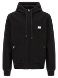Sweat-shirt noir en coton de Dolce & Gabbana avec logo discret, porté sur mannequin, vue de face.