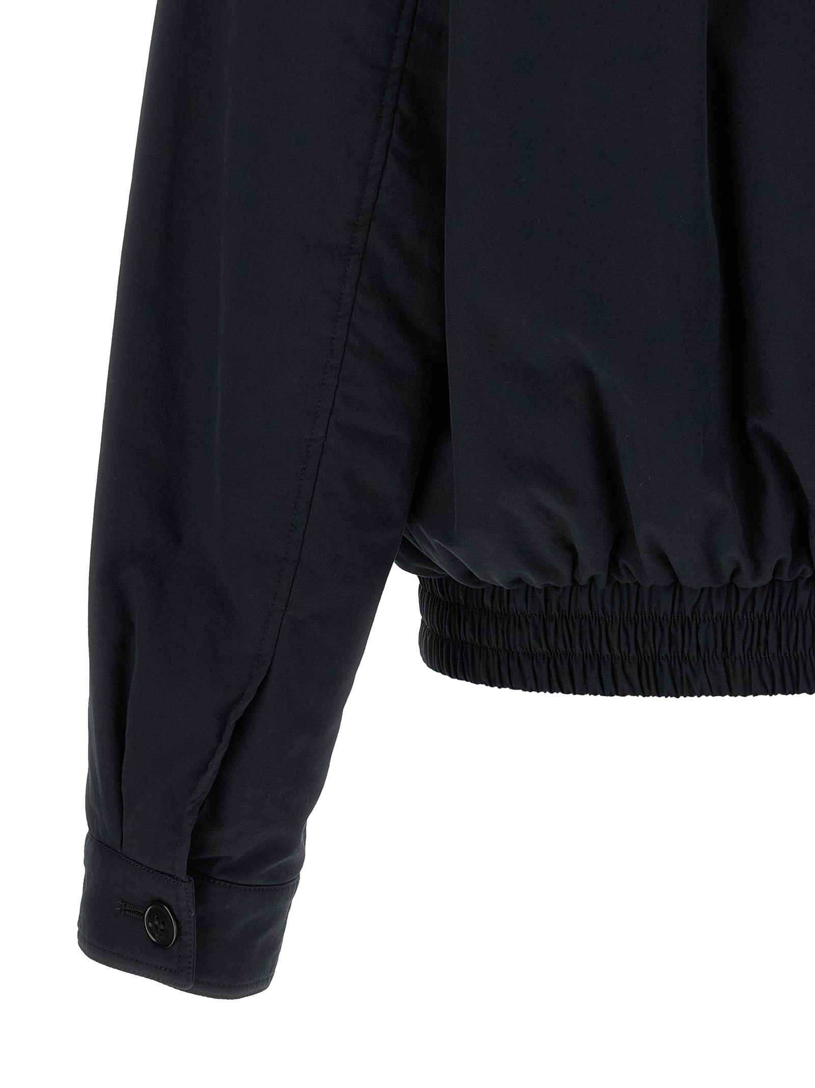Veste en coton noire Saint Laurent, coupe shell, avec fermeture zippée et col montant, vue de face.