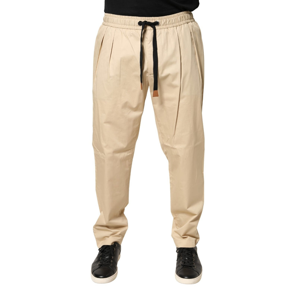 Pantalon jogger homme Dolce & Gabbana beige en coton skinny, ajusté et confortable, avec ceinture et poches visibles.