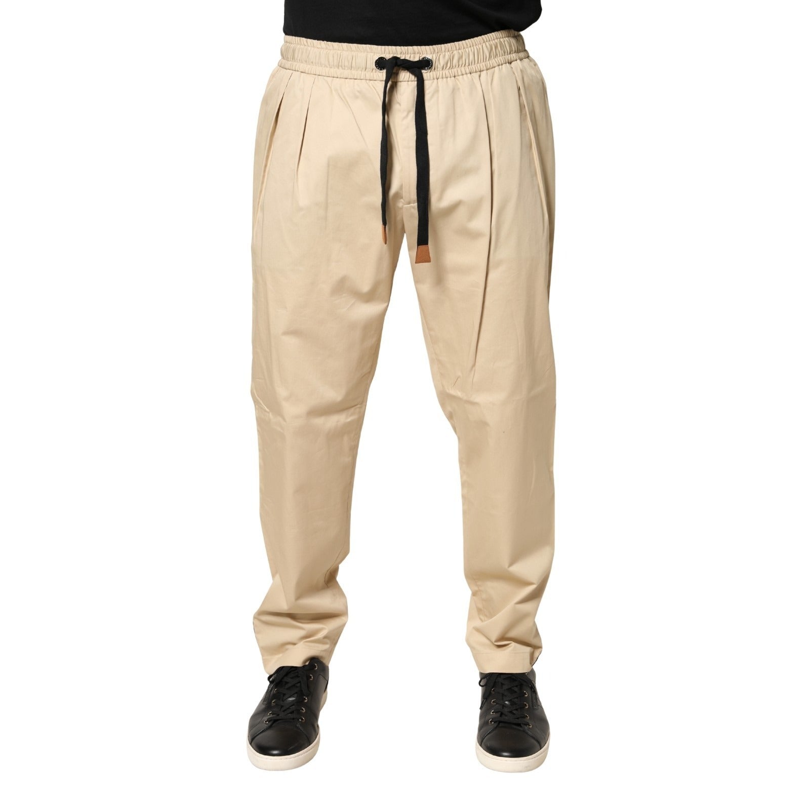 Pantalon jogger homme Dolce & Gabbana beige en coton skinny, ajusté et confortable, avec ceinture et poches visibles.