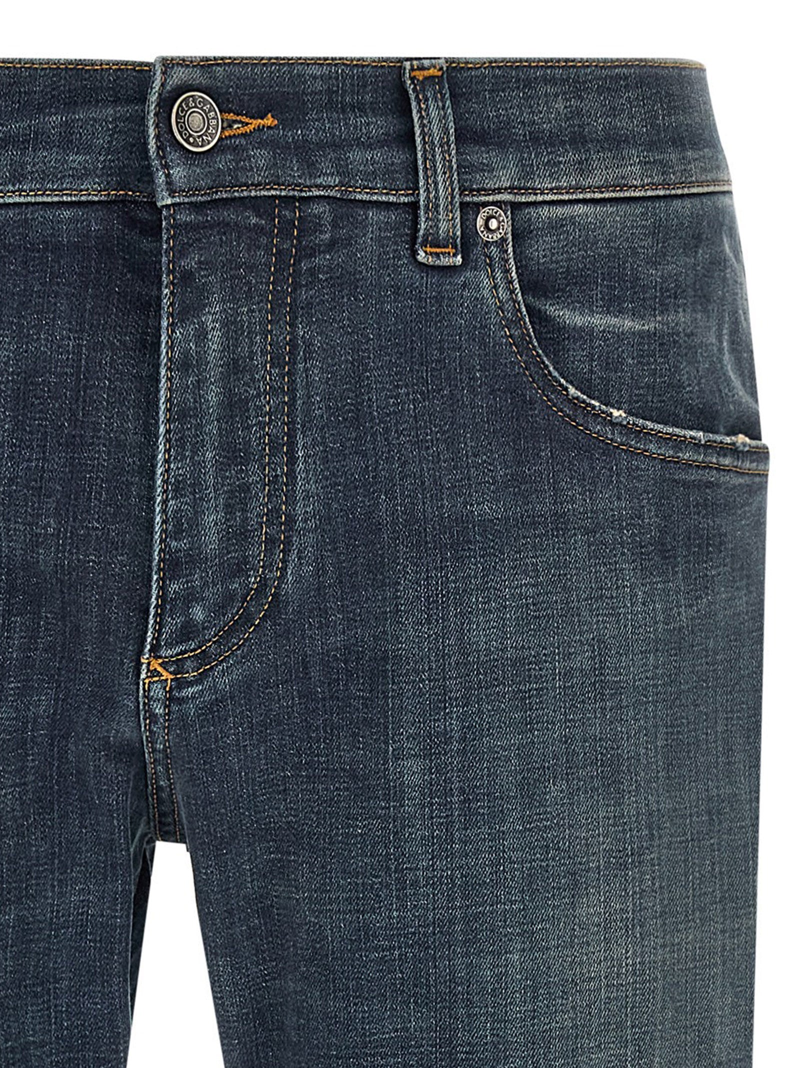 Jeans droits en coton bleu Dolce & Gabbana, style classique, visibles en détail dans l'image.