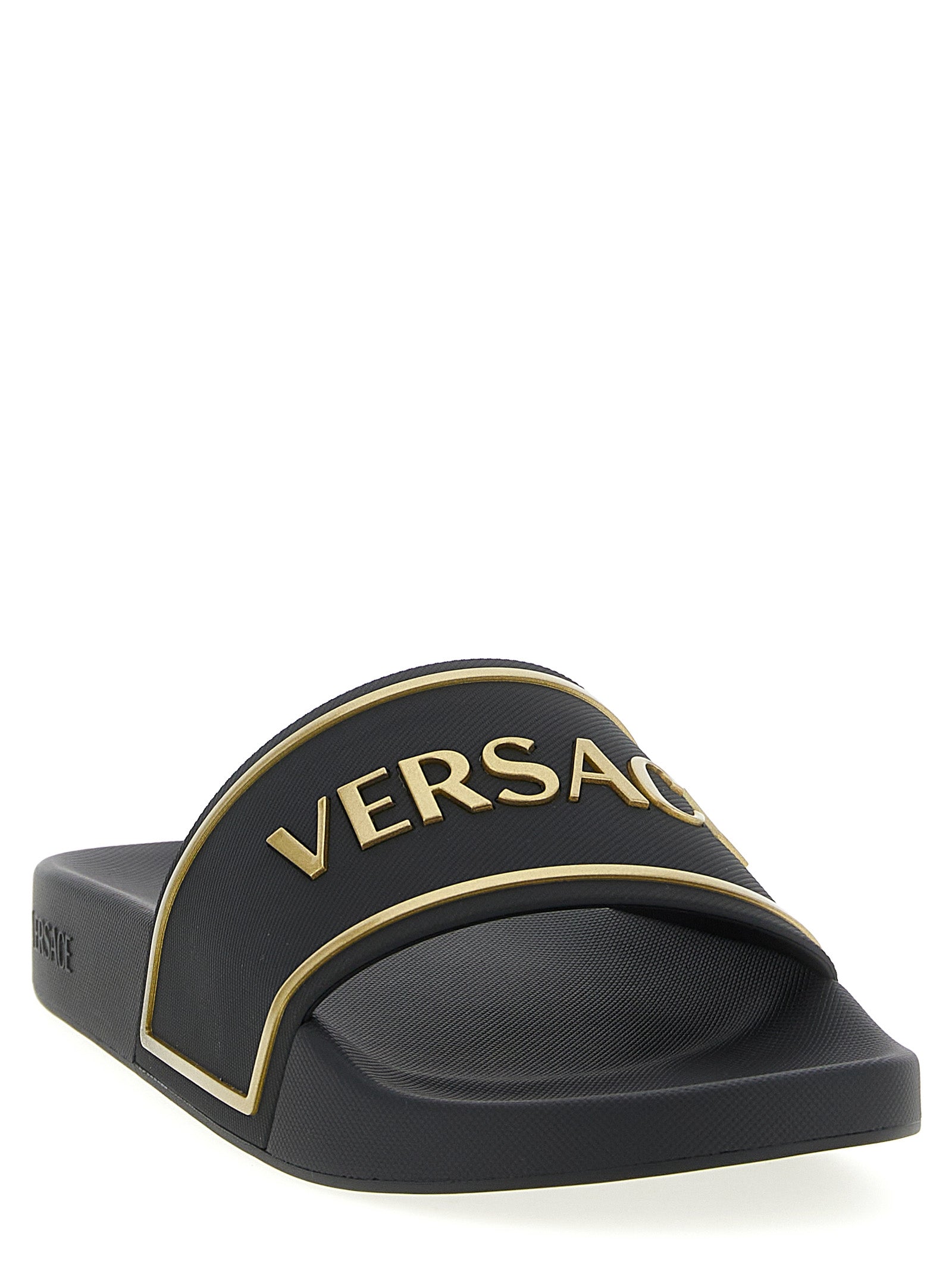 Sandales noires en polyuréthane de Versace, style élégant avec logo distinctif, parfaites pour un look sophistiqué.