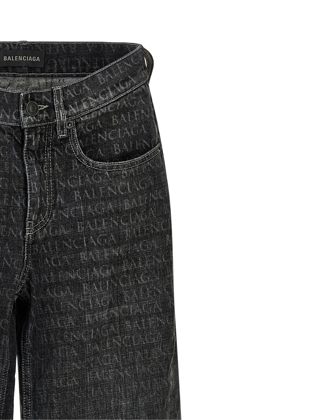 Jeans évasés en coton noir de la marque Balenciaga, avec coupe tendance et détails modernes, visibles en gros plan.