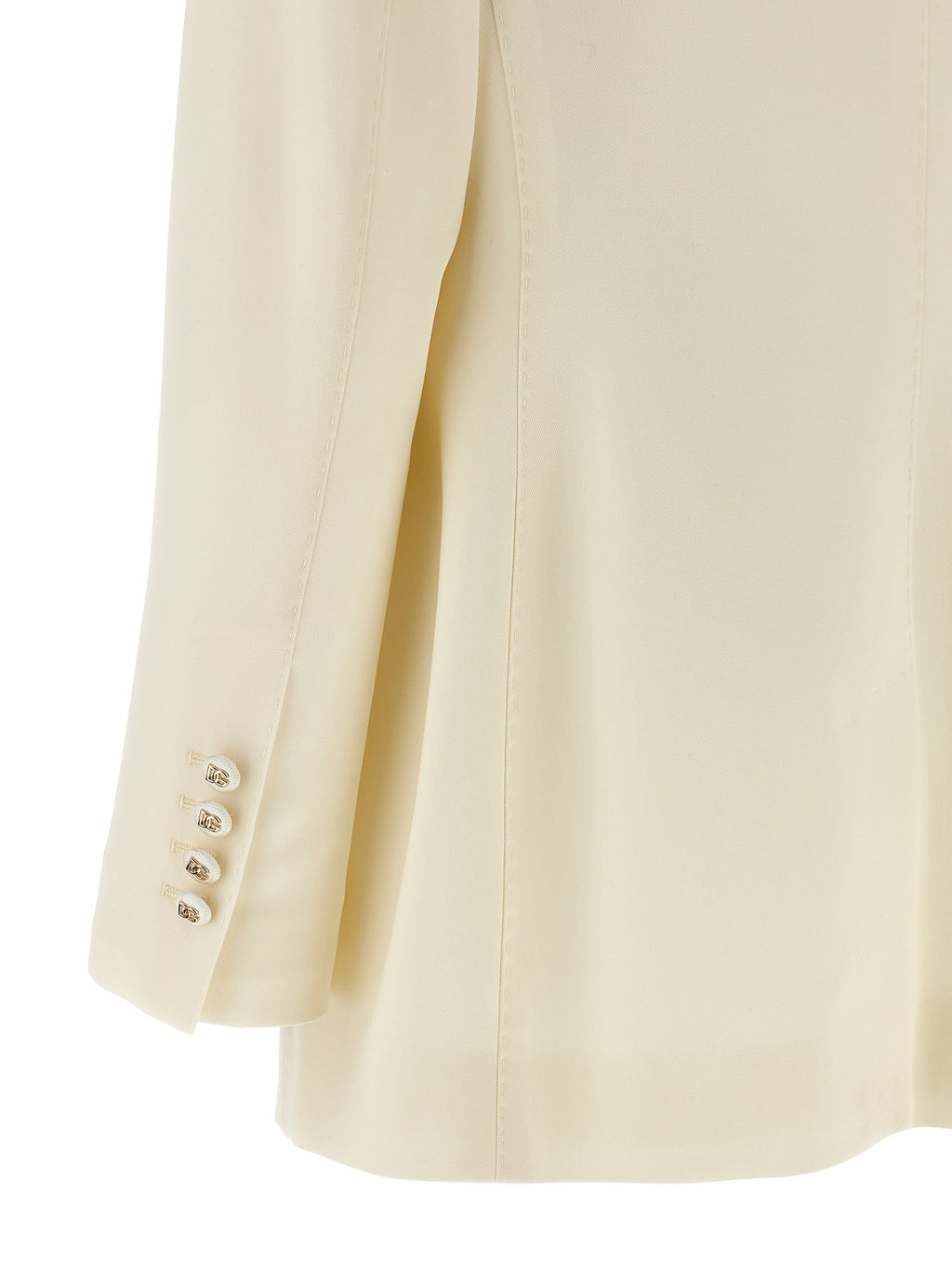 Blazer blanc en laine vierge Dolce & Gabbana porté sur un mannequin, détails élégants et coupe sophistiquée visible.