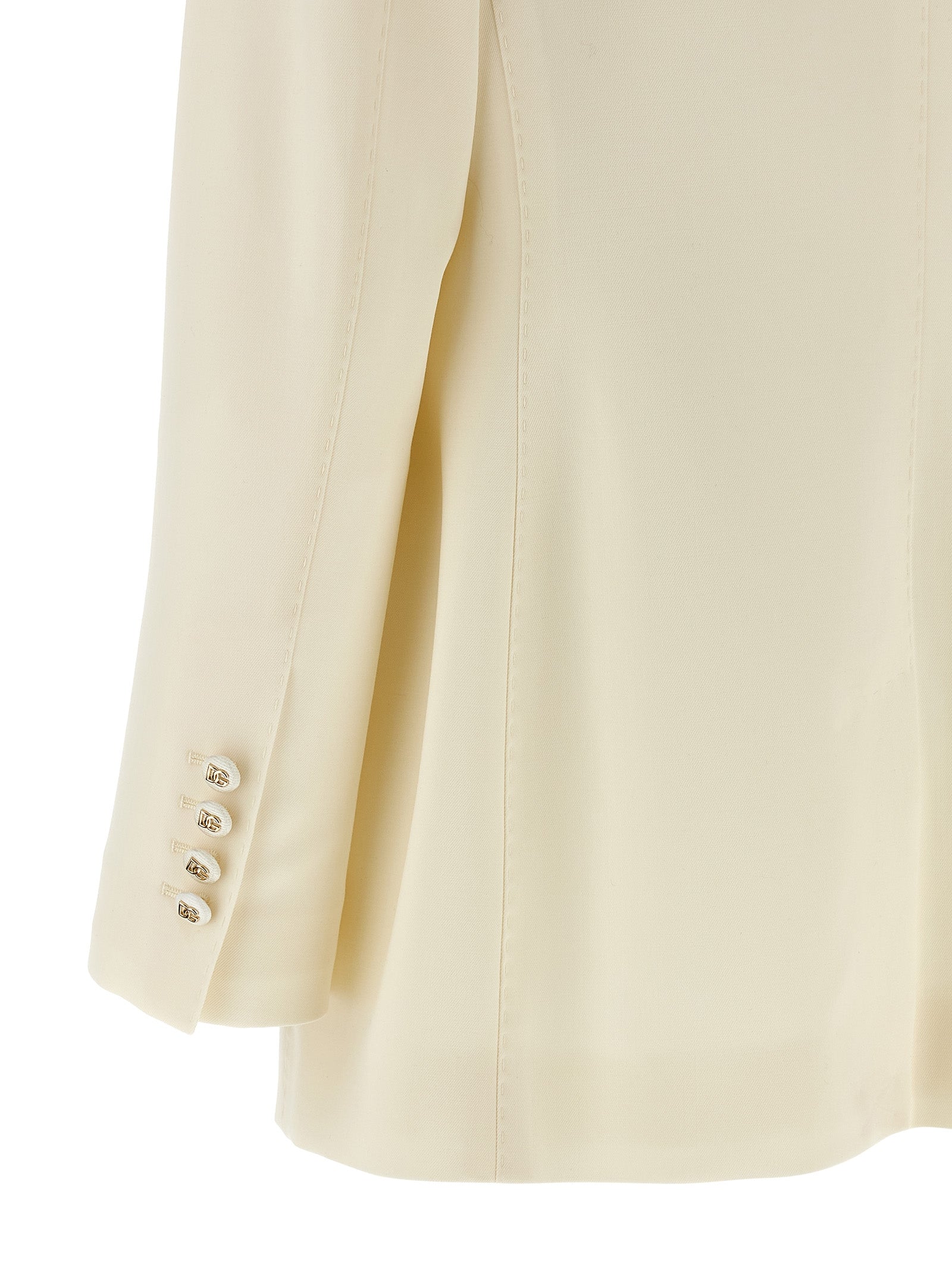 Blazer blanc en laine vierge Dolce & Gabbana porté sur un mannequin, détails élégants et coupe sophistiquée visible.