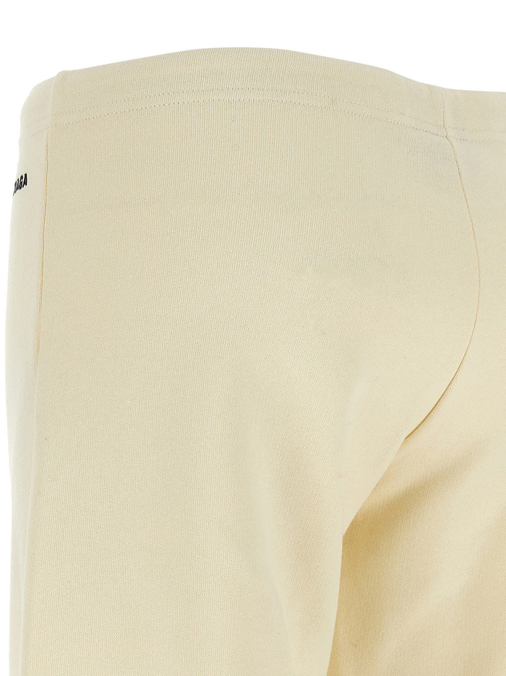 Pantalons évasés en coton blanc de Balenciaga, mode élégante avec coupe fluide et détails modernes, visible sur l'image.
