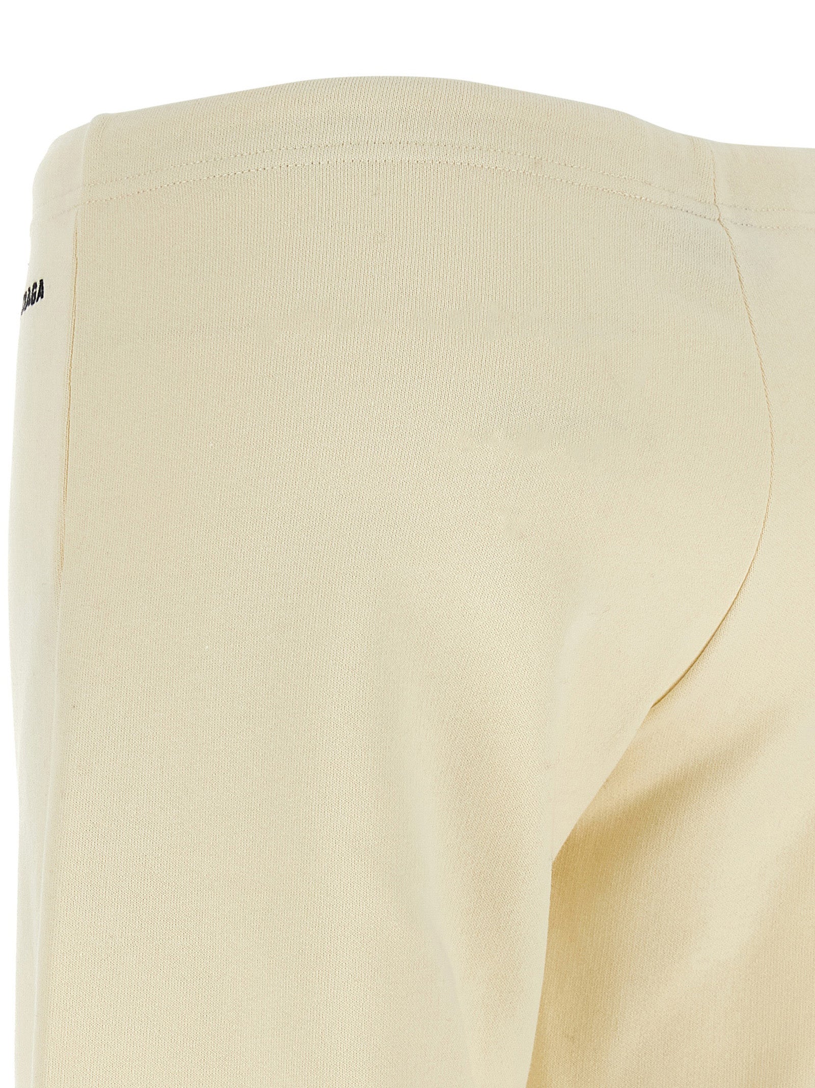 Pantalons évasés en coton blanc de Balenciaga, mode élégante avec coupe fluide et détails modernes, visible sur l'image.