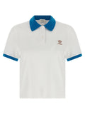 Chemise polo en coton bleu de la marque Versace, avec logo et design élégant visible sur le devant.