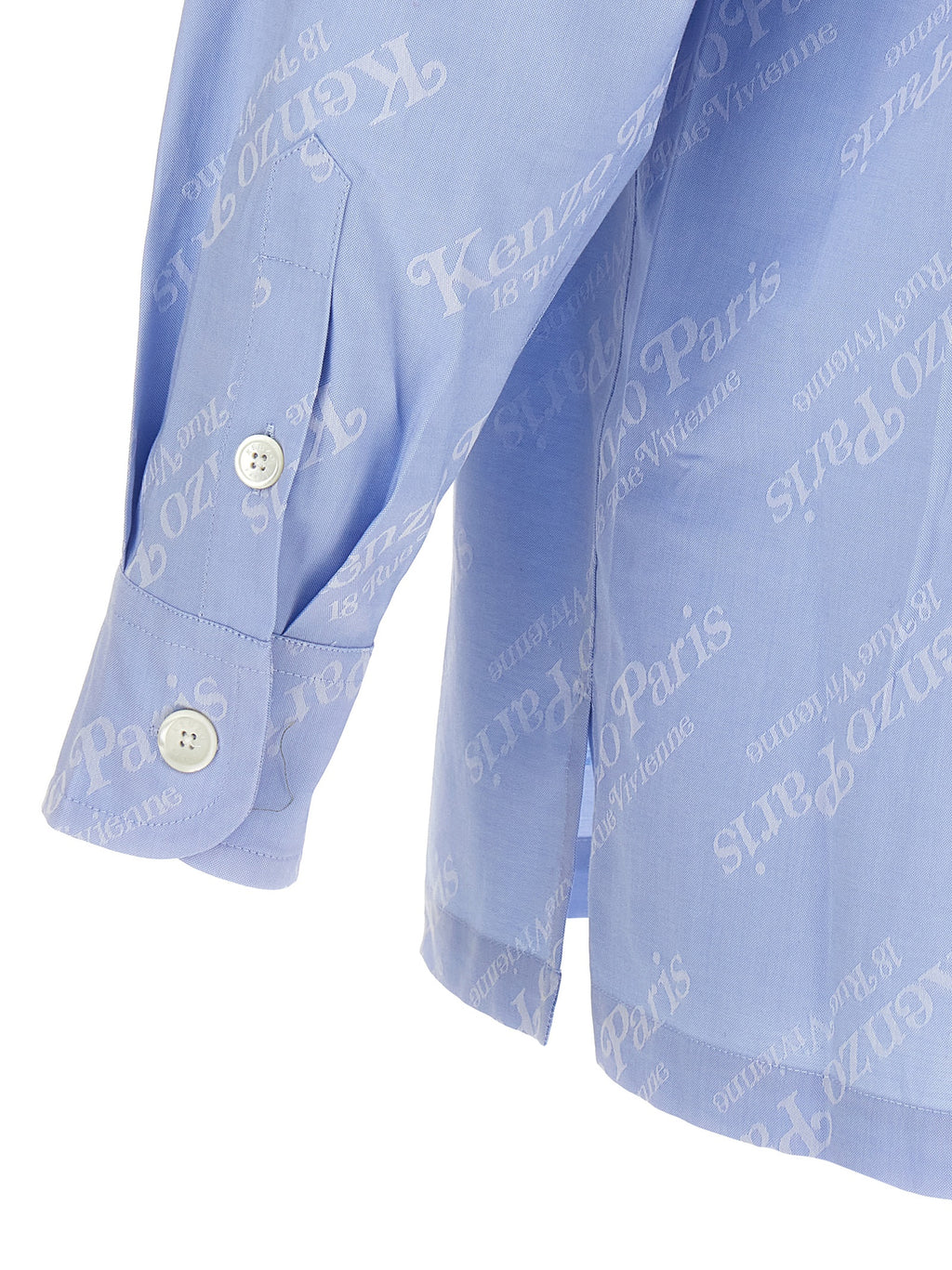 Chemisier en coton bleu de la marque Kenzo avec détail élégant, porté de face, sur fond blanc.