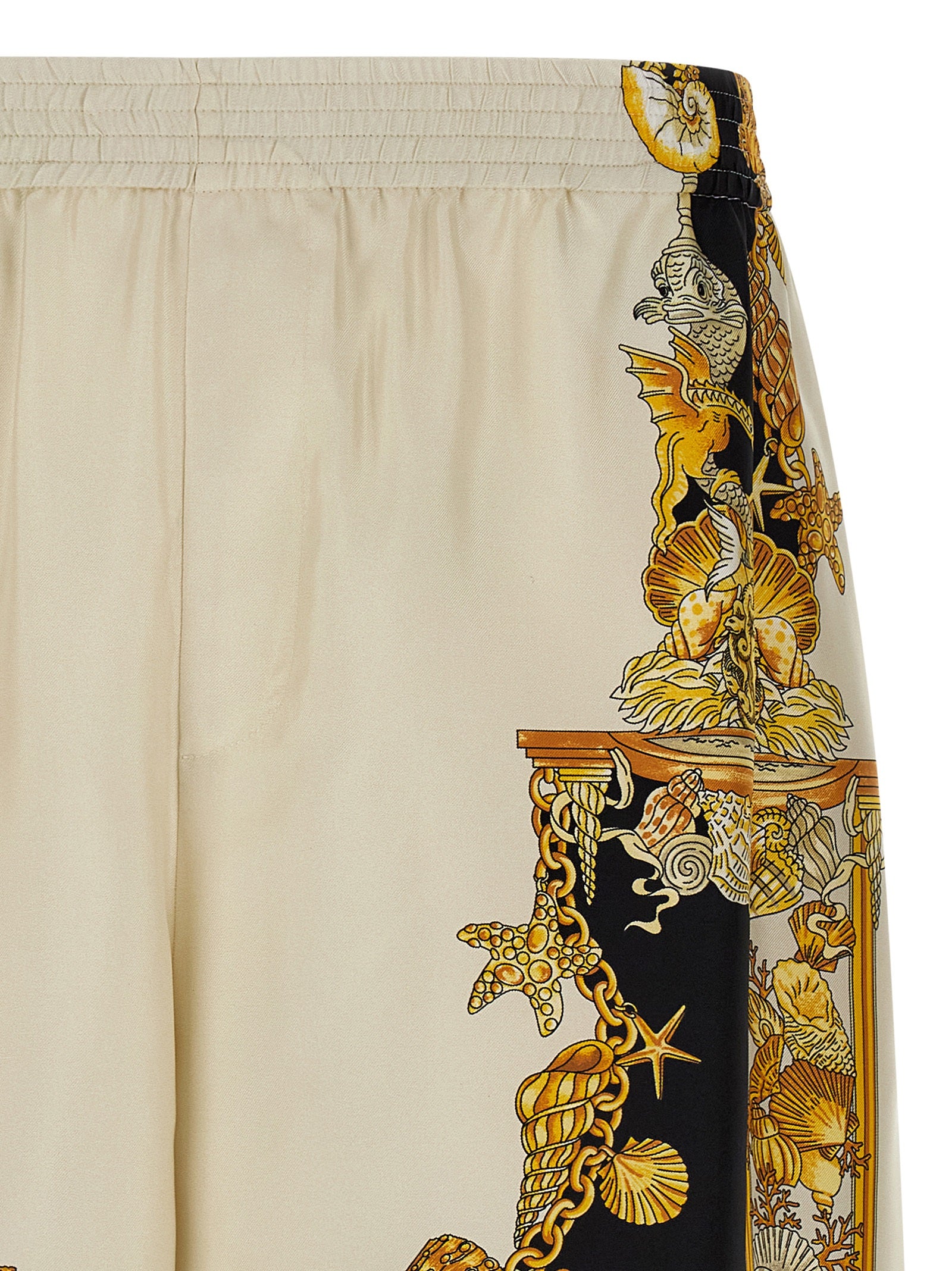 Shorts bermuda en soie multicolore de Versace, style élégant avec motif vibrant, vues en détail sur le tissu et la coupe.