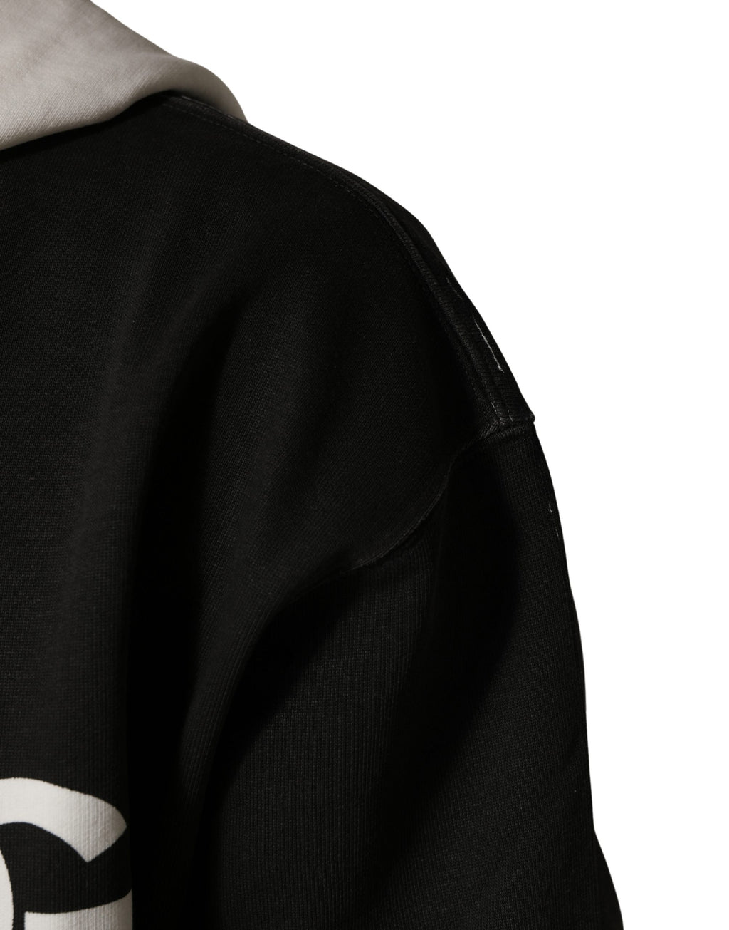 Sweat à capuche noir en coton Dolce & Gabbana avec logo, fermeture éclair complète, coupe décontractée, visible en gros plan.