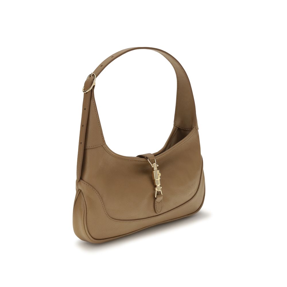 Sac à main beige en cuir de chèvre Gucci, élégant et sophistiqué, avec détails raffinés visibles sur l'image.