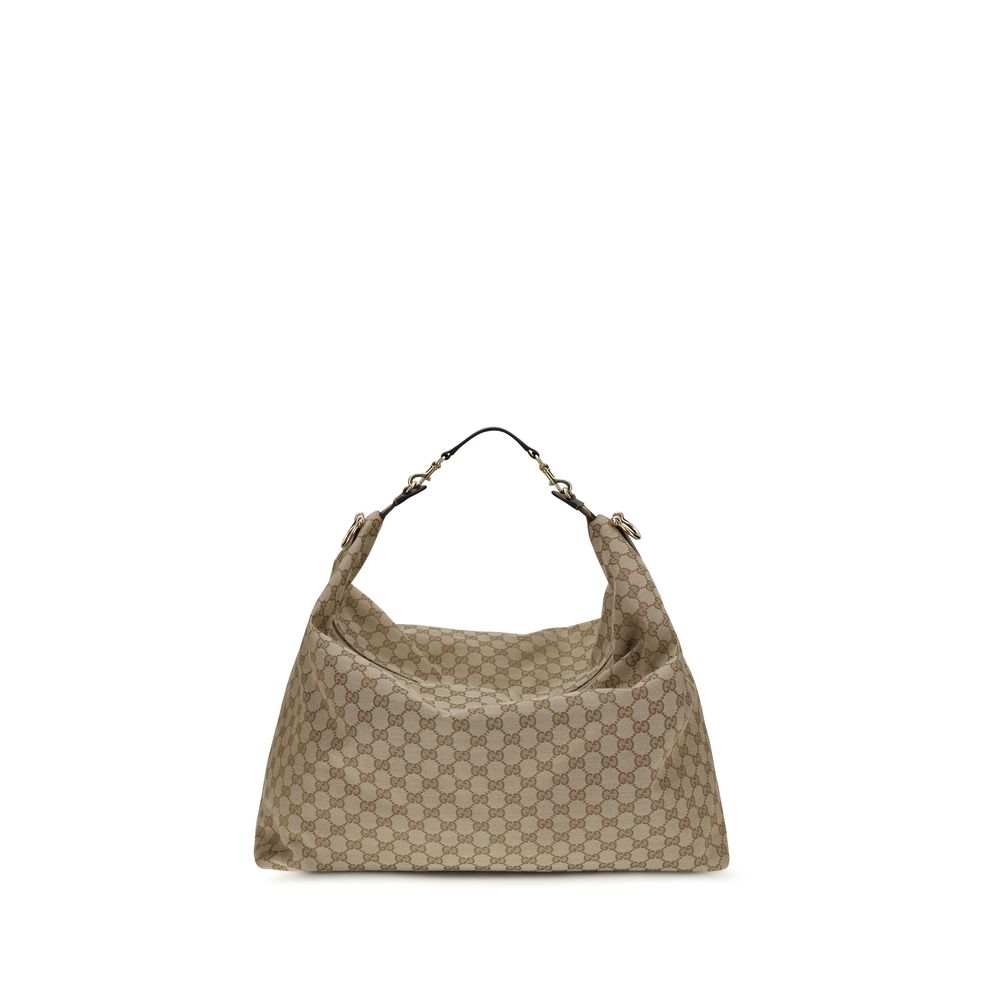 Sac à bandoulière en tissu beige Gucci, mode élégante avec logo Gucci visible sur le devant.