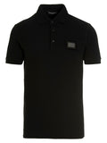 Chemise polo noire en coton de Dolce & Gabbana, style élégant avec col et boutons visibles.
