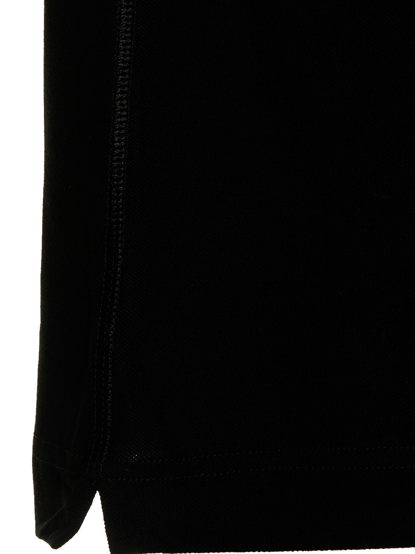 Chemise polo en coton noir de Dolce & Gabbana, vue de face, avec col classique et logo discret sur la poitrine.