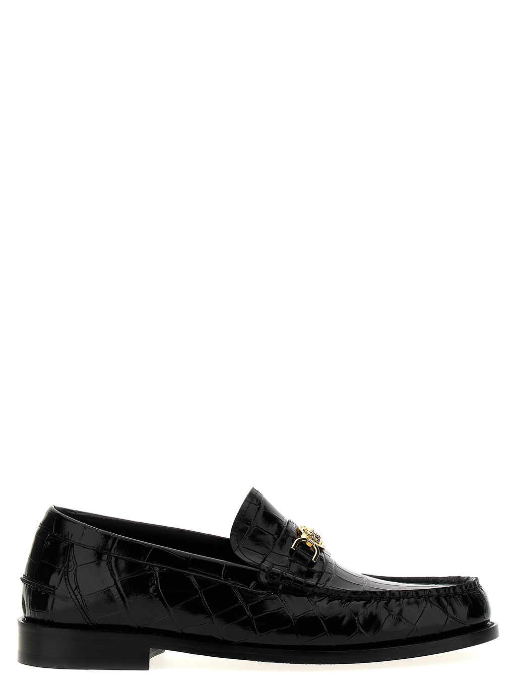 Mocassins en velours noir en cuir de la marque Versace, style slip-on, avec détails élégants visible sur l'image.