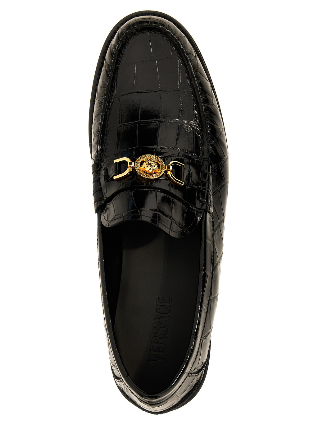 Mocassins en velours noir en cuir slip-on de Versace, élégants et sophistiqués, visibles en gros plan.