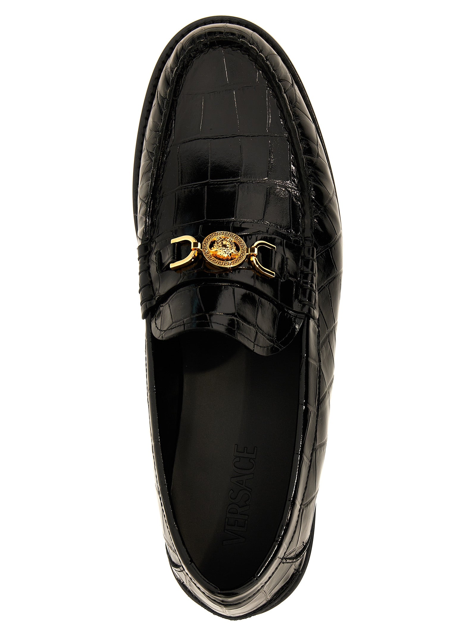 Mocassins en velours noir en cuir slip-on de Versace, élégants et sophistiqués, visibles en gros plan.