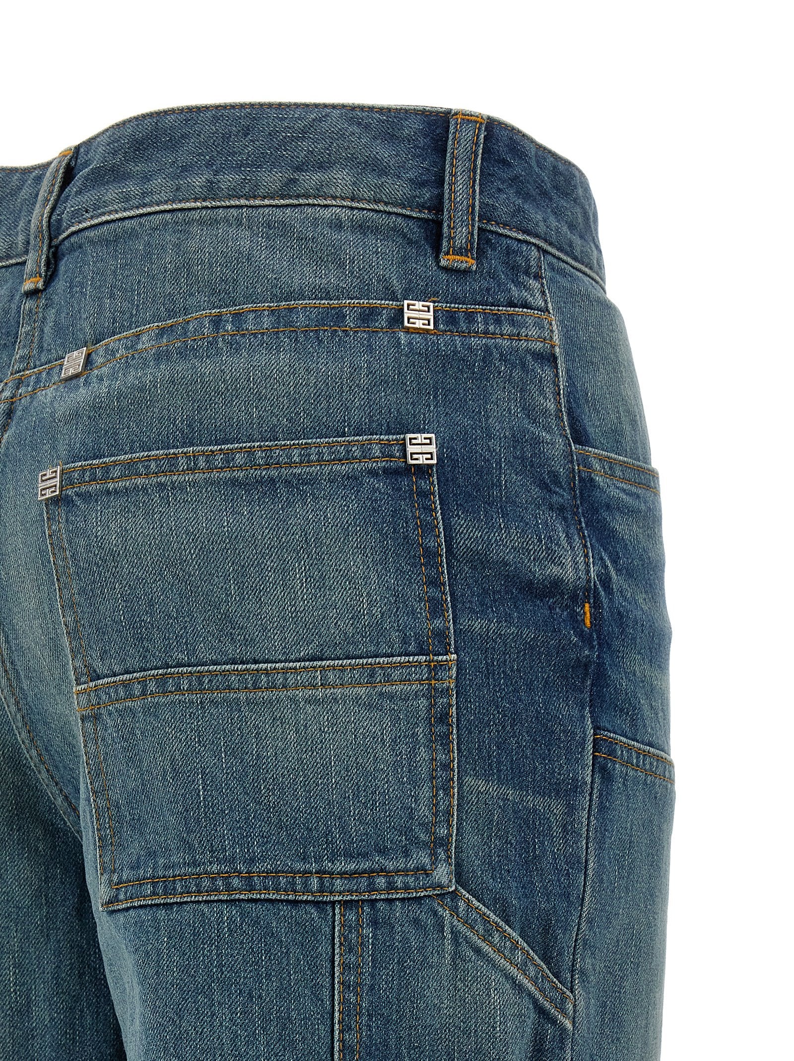 Jeans évasés en coton bleu de la marque Givenchy, coupe tendance et style décontracté, visible en gros plan.