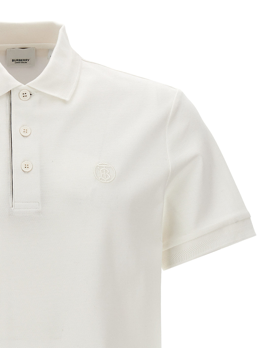 Chemise polo blanche en coton de la marque Burberry, avec col classique et logo discret sur la poitrine.