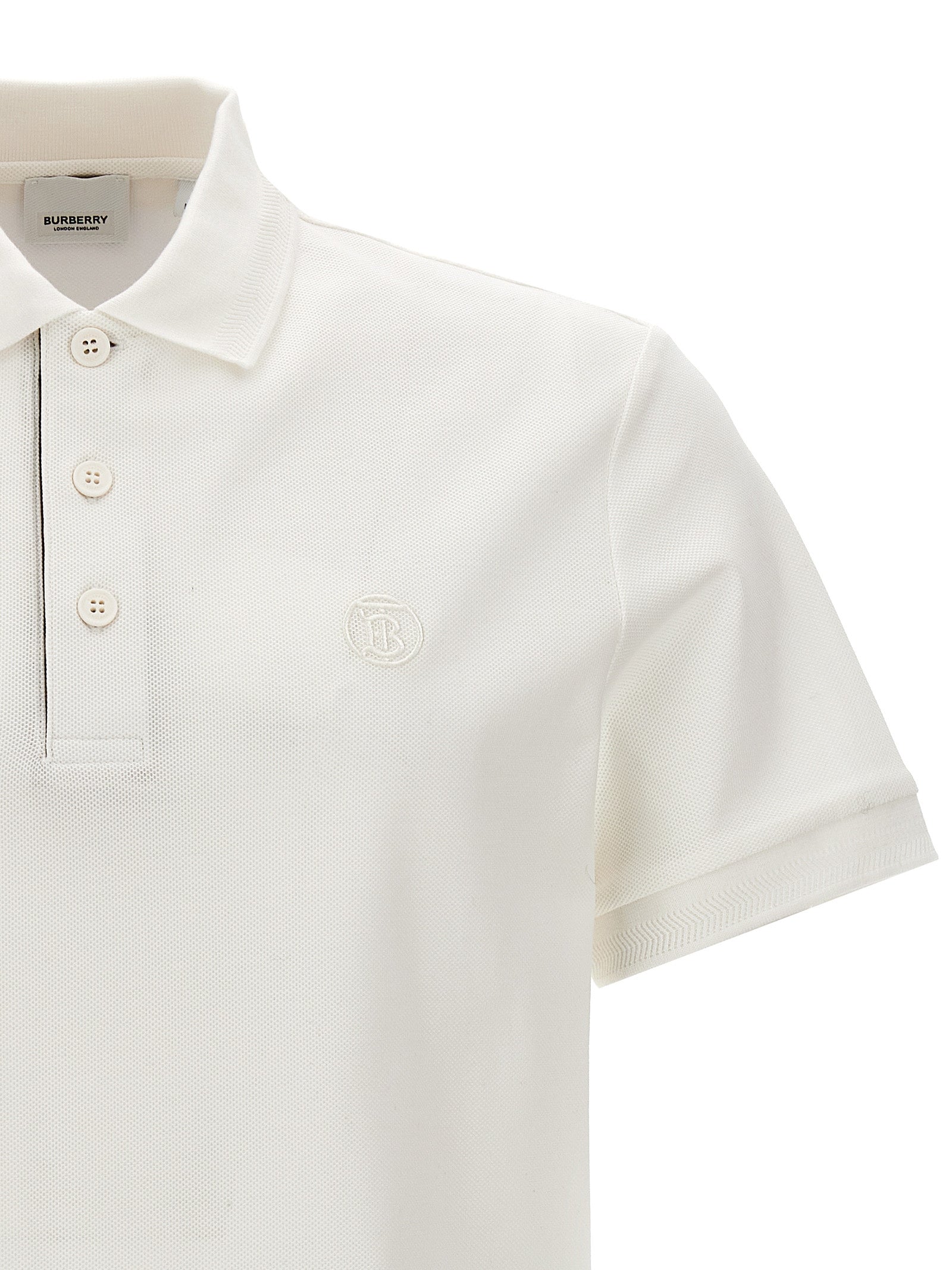 Chemise polo blanche en coton de la marque Burberry, avec col classique et logo discret sur la poitrine.
